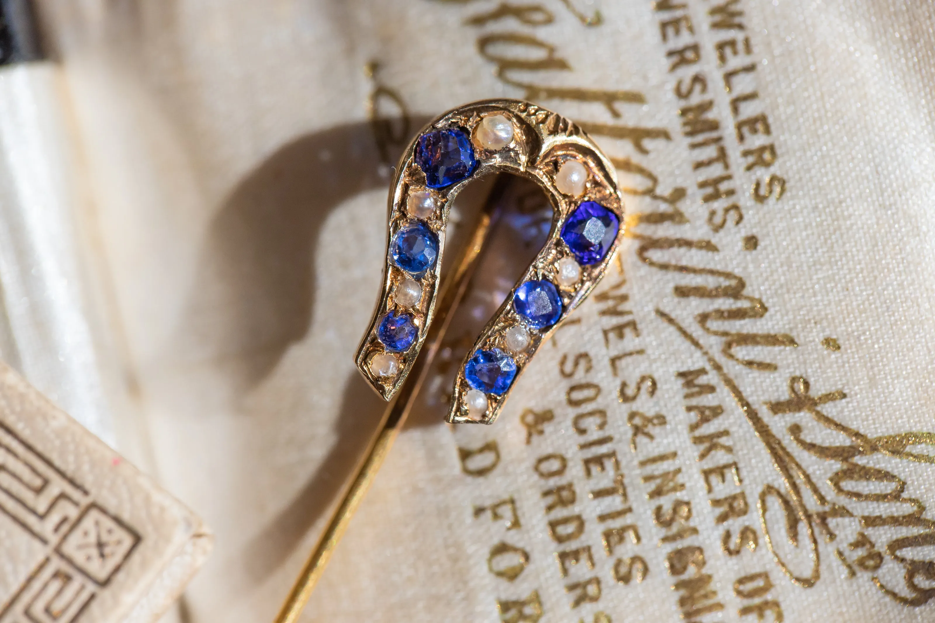 Early Victorian High Karat Gold 0.78 CTW Cornflower Spinel & Seed Pearl Horseshoe Stick Pin