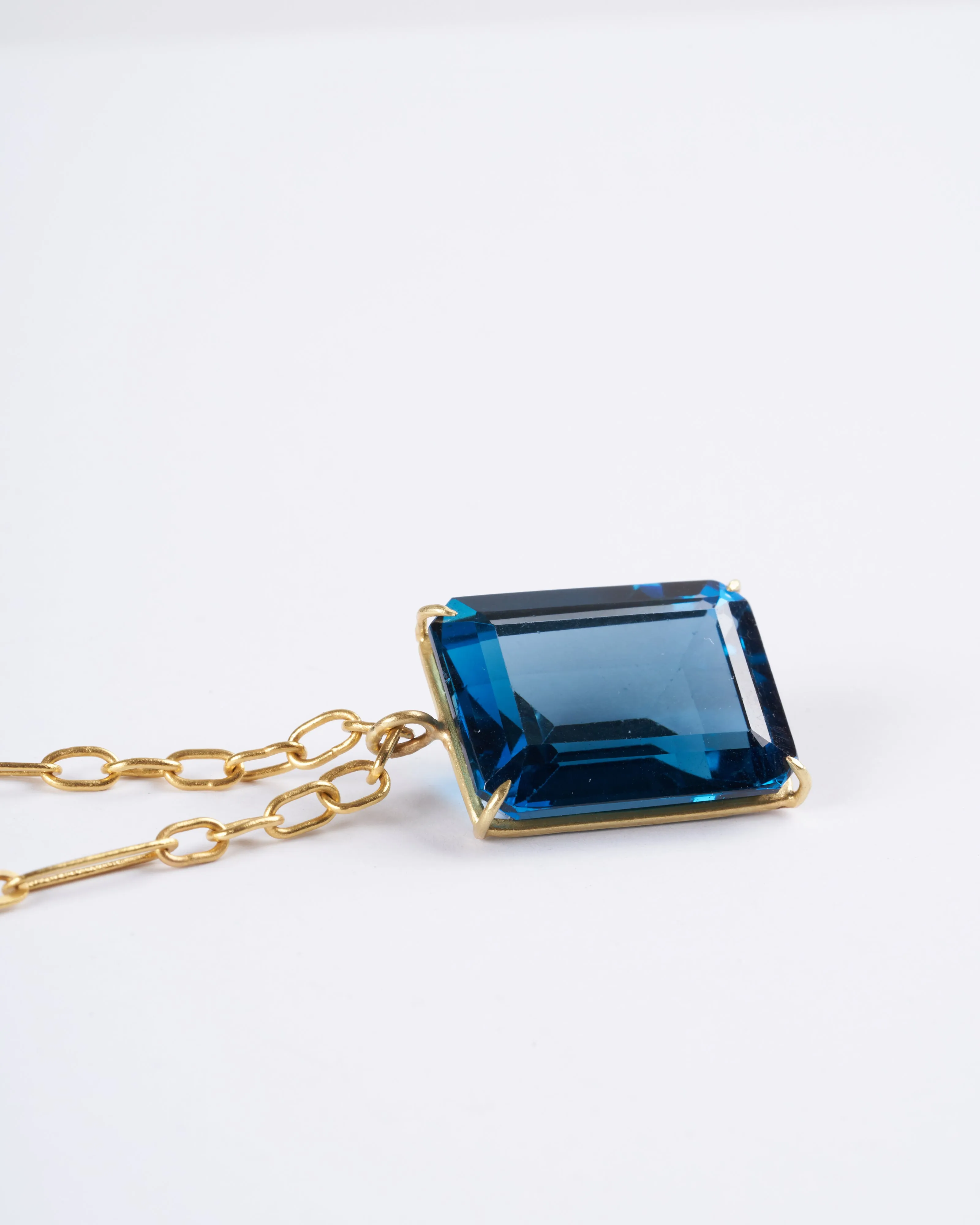 emerald cut london blue topaz set in yellow gold