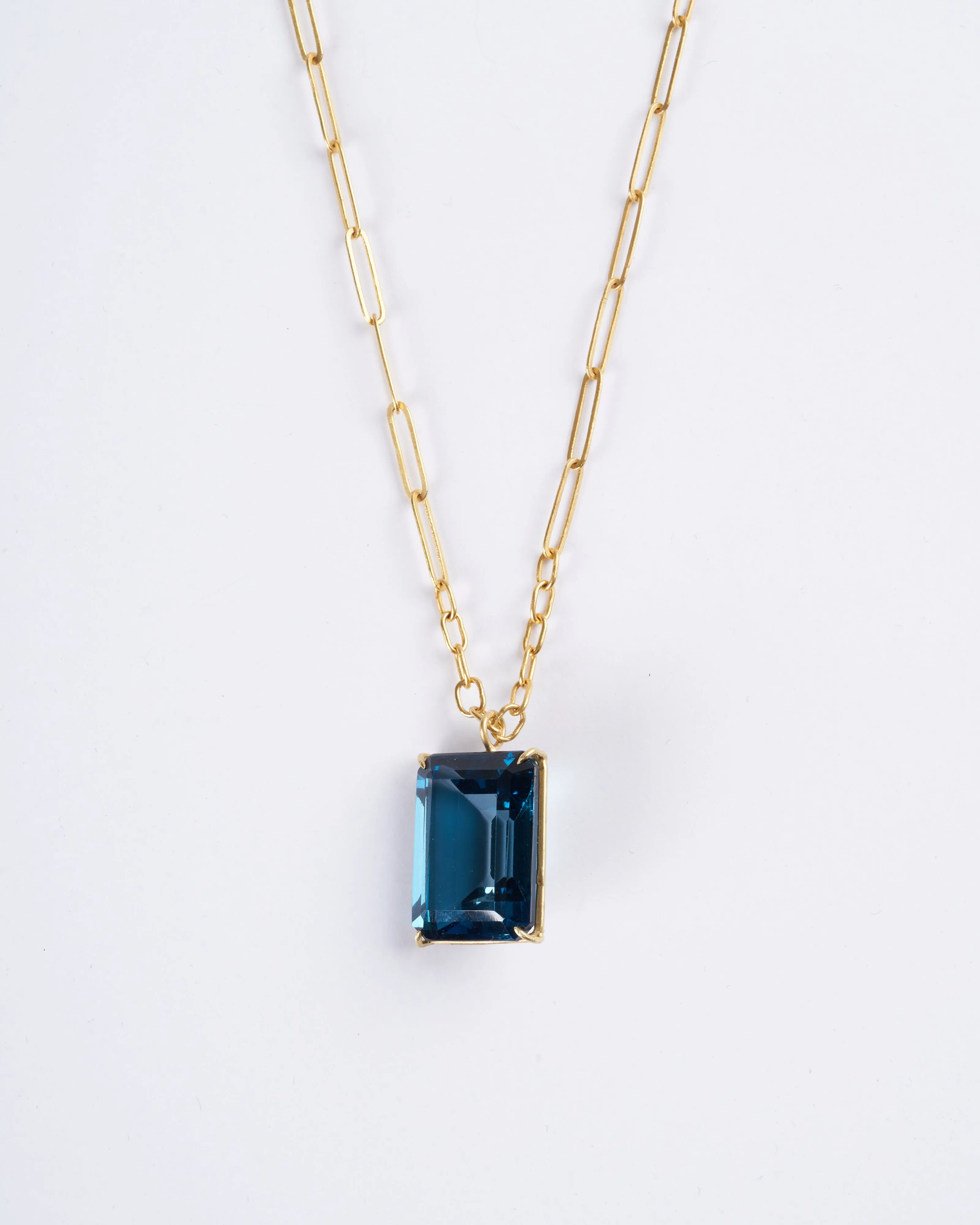 emerald cut london blue topaz set in yellow gold
