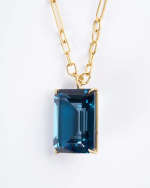 emerald cut london blue topaz set in yellow gold