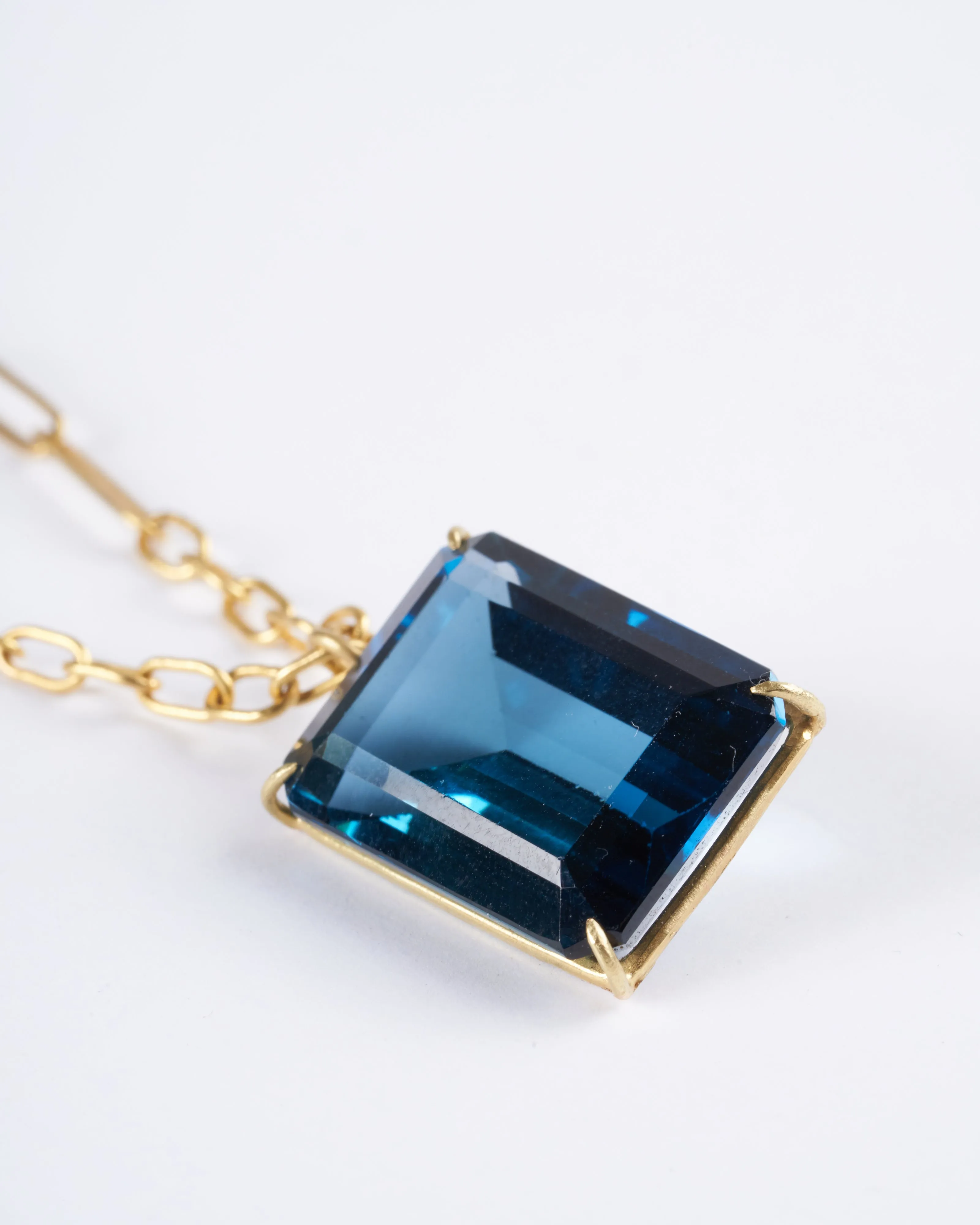 emerald cut london blue topaz set in yellow gold